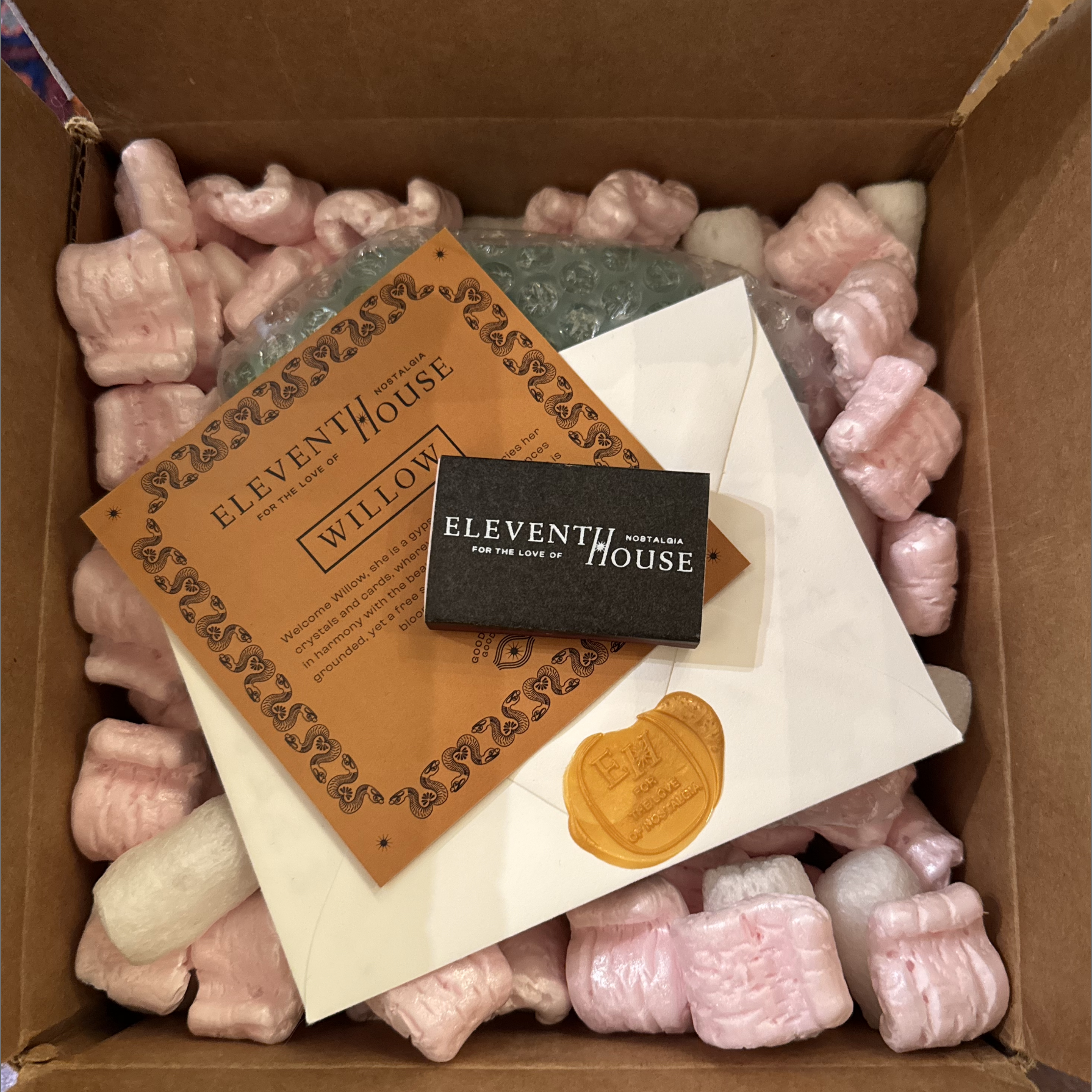 Eleventh House unboxing experience with candle, hand-written notes, and match sticks