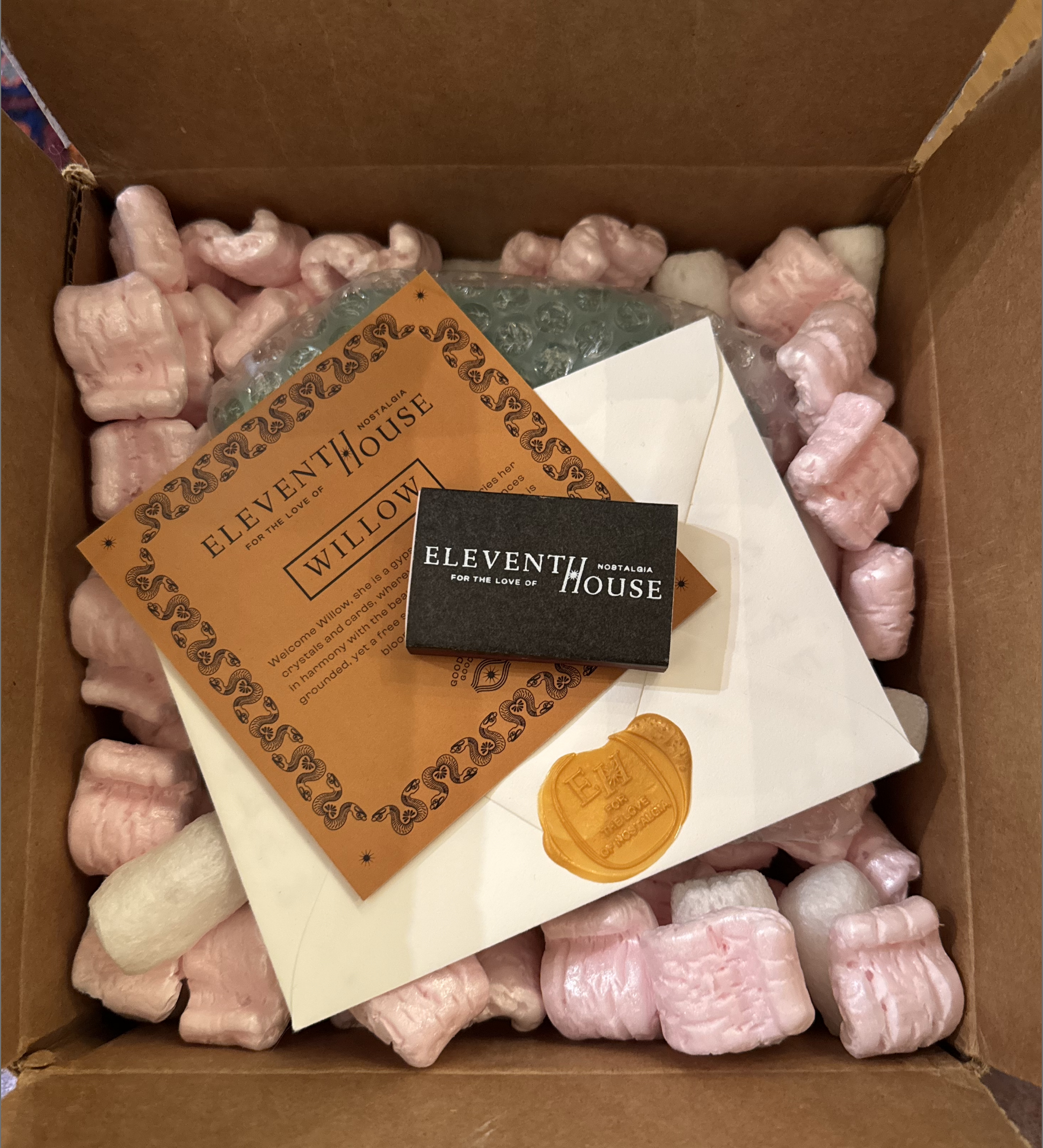 Eleventh House unboxing experience with candle, hand-written notes, and match sticks
