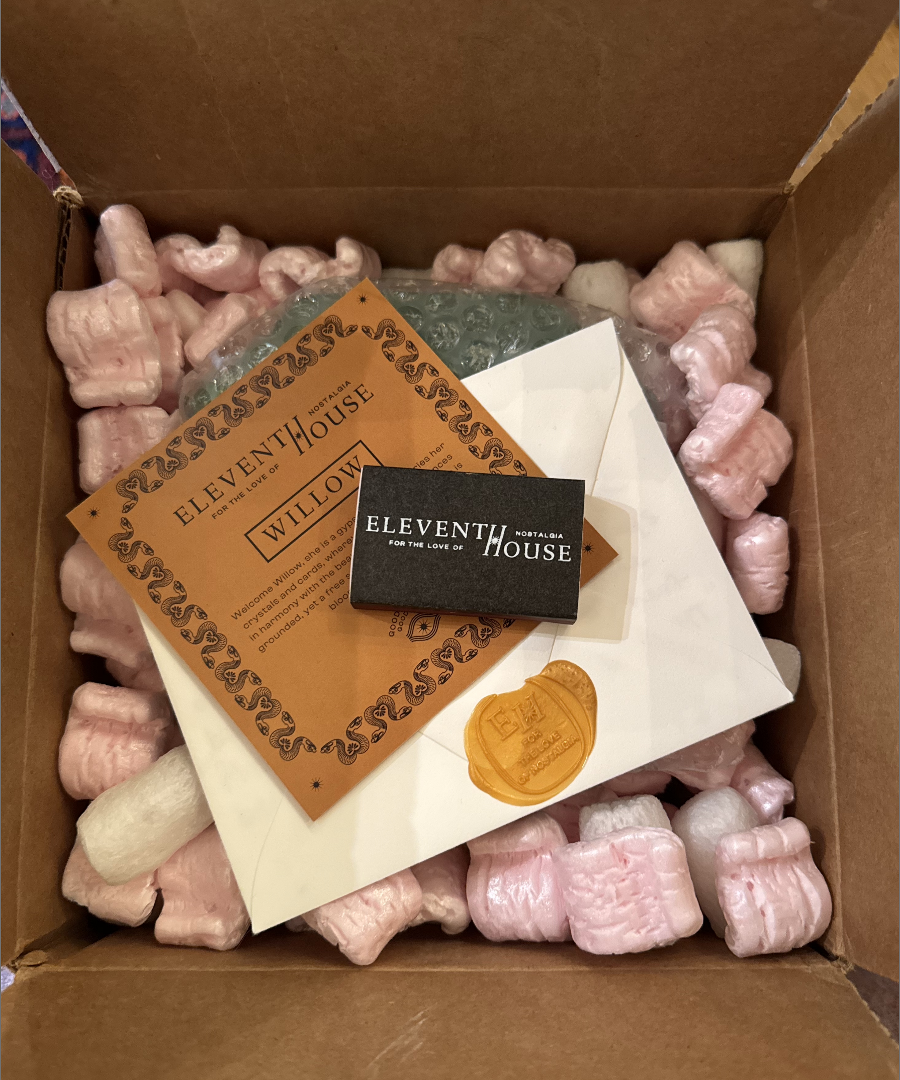 Eleventh House unboxing experience with candle, hand-written notes, and match sticks